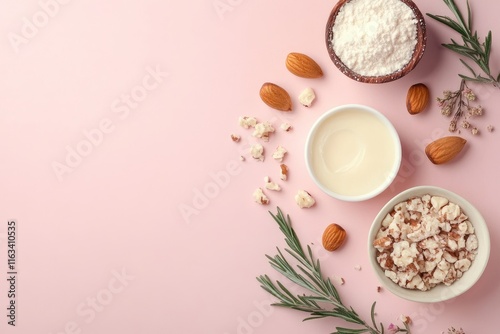 Almond and Rosemary Skincare Ingredients Arranged on Pink Background photo