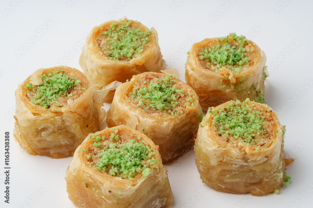 Mouthwatering traditional dessert featuring layers of pastry and nuts topped with green pistachio Mouthwatering traditional dessert featuring layers of pastry and nuts topped with green pistachio