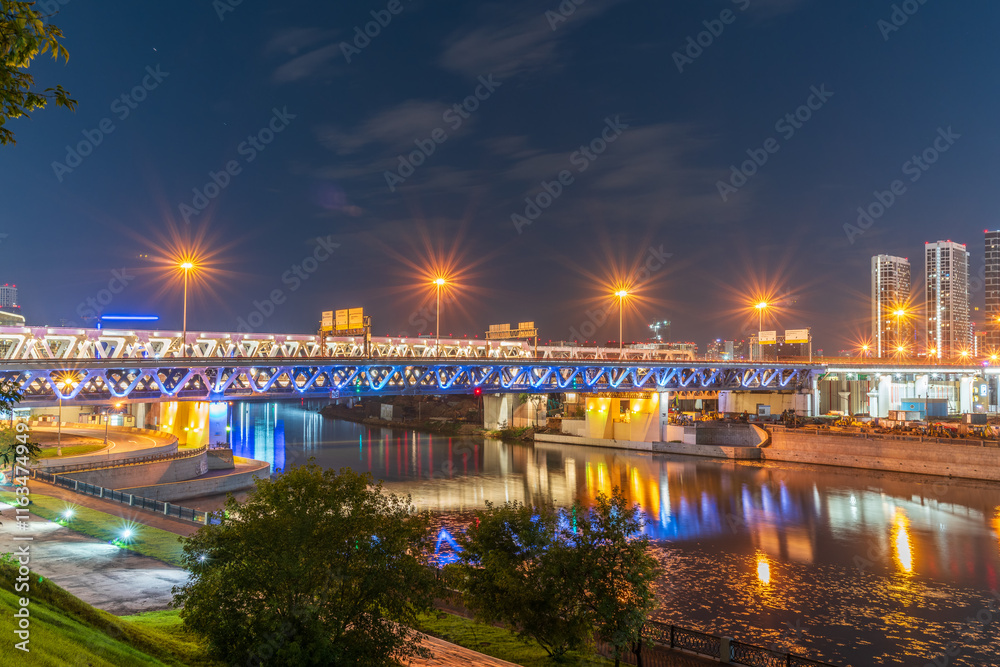 The scyscrapers of the Moscow City at night and the Dorogomilovsky bridge with illumination. Translation of text - street names: Krasnopresnenskaya, center, etc. The scyscrapers of the Moscow City at night and the Dorogomilovsky bridge with illumination. Translation of text - street names: Krasnopresnenskaya, center, etc.