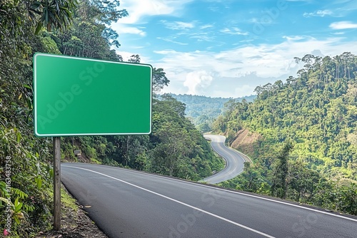 Green road sign on mountain highway, dense jungle, adventure backdrop.