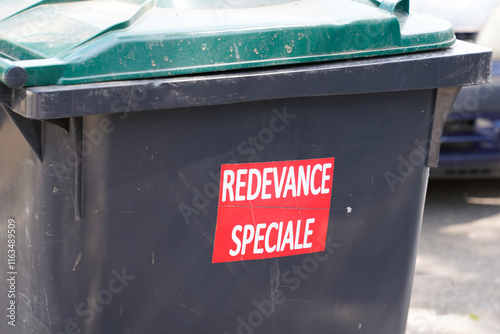 redevance speciale french text sign sticker on trash means charge special fee for garbage collection paid photo