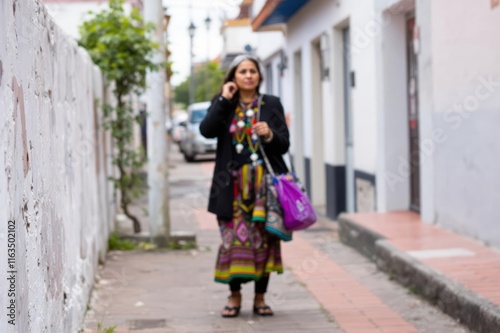 Native woman on the sidewalk in Peru photo