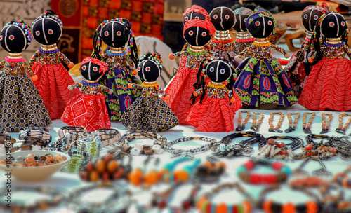 African art. Traditional southern African dolls, crafted from colorful beads. African unique traditional handmade colorful beads ragdolls. Local craft market in South Africa.
