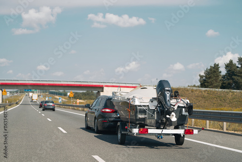 Фотография Vehicle with boat trailer driving on road