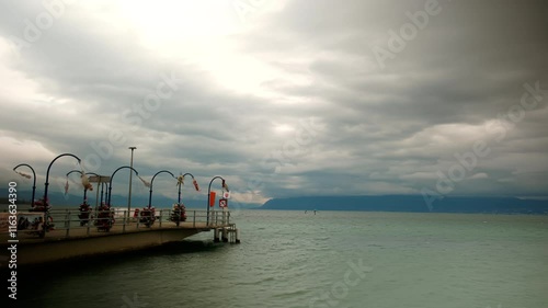 Timelapse of Morges wharf with clouds moving over Lake Geneva in Canton of Vaud Switzerland