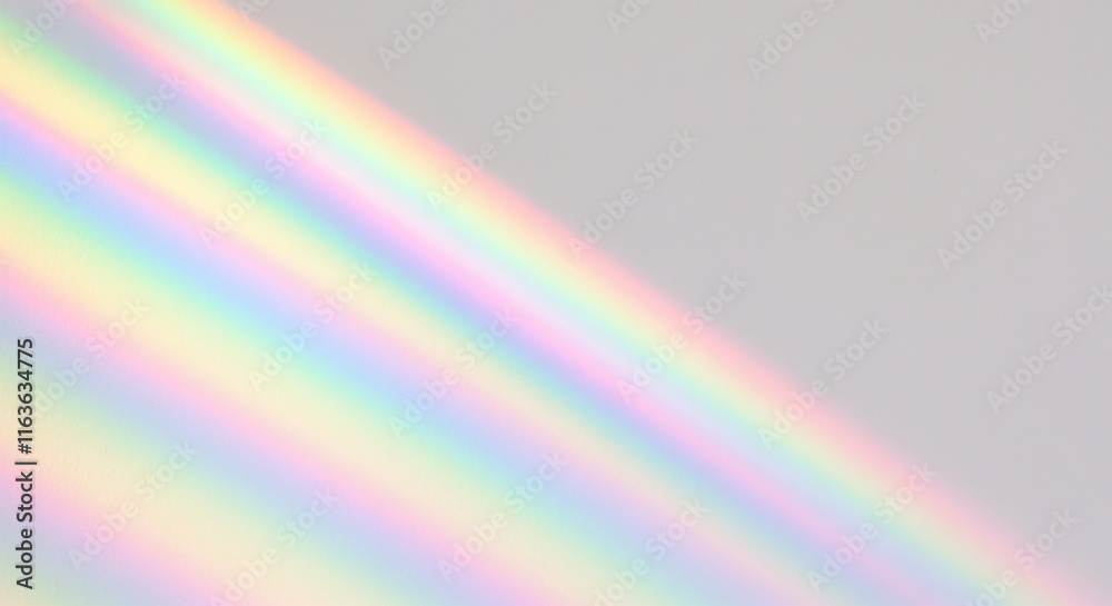 Obraz premium Blurred rainbow light refraction texture overlay effect for photo and mockups. Organic drop diagonal holographic flare on a white wall. Shadows for natural light effects