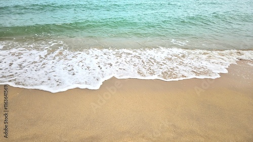 Sea water wave and sand beach with seashell background for decoration on summer holiday and coastal concept. photo