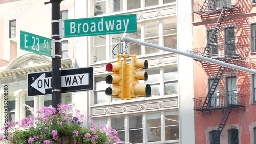 Broadway street road sign, Manhattan midtown architecture, New York City corner. Yellow traffic light. Flatiron district near Madison Square Park. Crossroad of 23 st., Bway and 5 Fifth avenue. One way