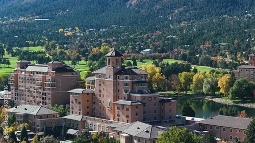 Aerial establishing telephoto of The Broadmoor resort surrounded by vibrant fall foliage in Colorado photo