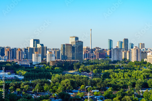 Skyline of Beijing CBD at sunrise with golden sunlight on skyscrapers