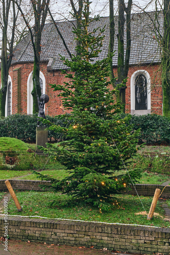 Christmas Tree with Lights in Front of Historic Church photo