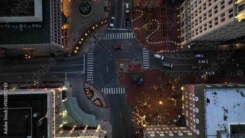 Lighting City with driving cars in downtown in christmas season. Night scene with christmas trees on square of city. Towers and skyline in winter. Aerial top down landing shot. photo