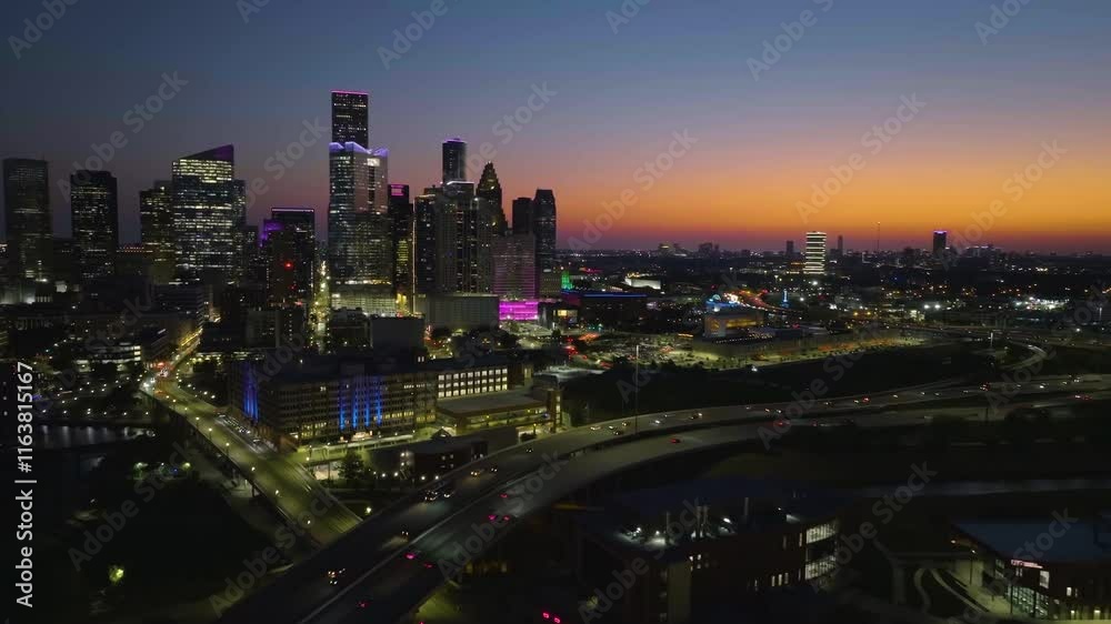 Aerial rising shot panning over the I90, toward the Houston skyline, dusk in USA Aerial rising shot panning over the I90, toward the Houston skyline, dusk in USA