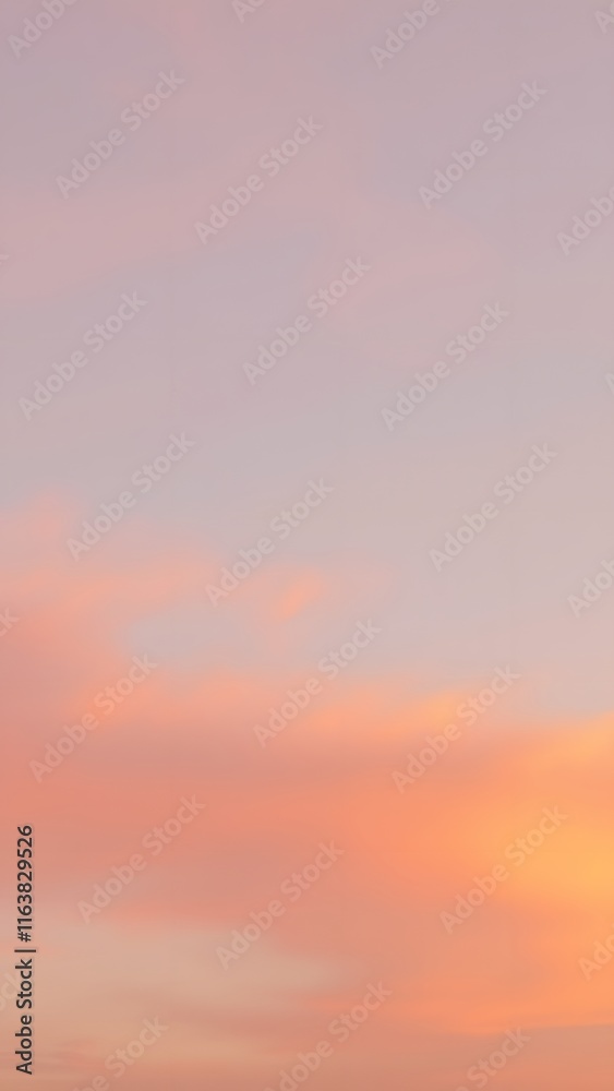 Fototapeta premium Pastel Sunset with Soft Clouds - Vertical Phone Wallpaper Background