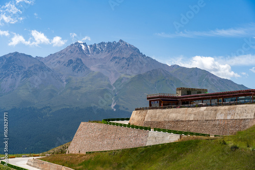 Under the blue sky and white clouds, the Qilian Mountains are covered in snow.