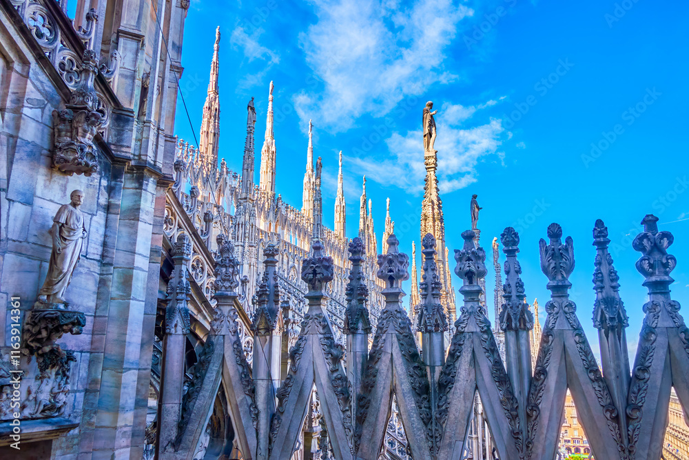 Milan Cathedral is a Gothic masterpiece with ornate spires, intricate sculptures, and detailed carvings, Italy