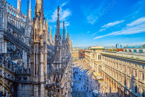 The roof of Milan Cathedral with a forest of spires, carved stone gargoyles, and detailed walls, Italy