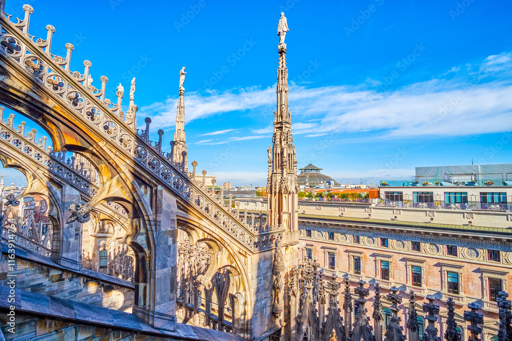 Gothic flying buttresses with intricate carvings on the roof of Milan Cathedral, Italy