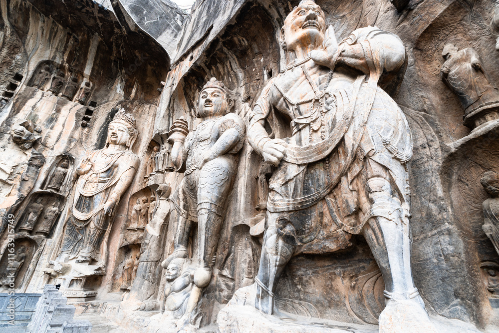 Luoyang Longmen, China: Ancient Buddhist statues in the Longmen grottes Fengxian main cave that dates back from the 7th century in Central China.