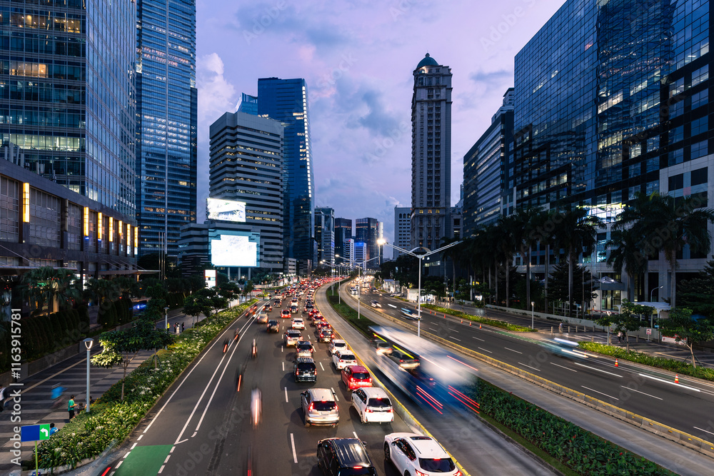 Naklejka premium Jakarta, Indonesia: Traffic during rush hour along the Sudirman avenue in the heart of Jakarta business and financial district in Indonesia capital city.