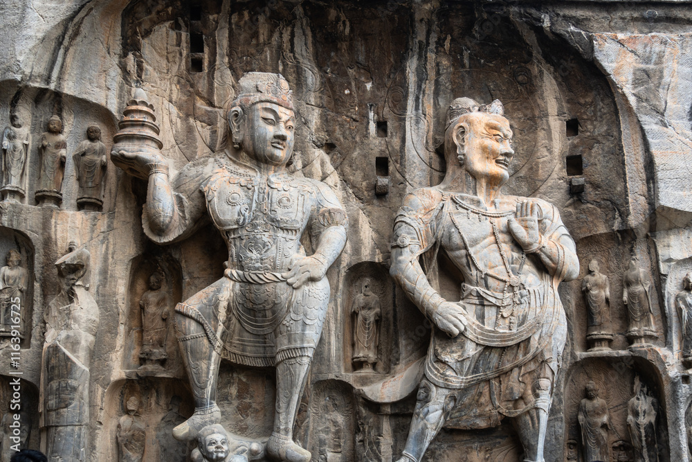 Luoyang Longmen, China: Ancient Buddhist statues in the Longmen grottes Fengxian main cave that dates back from the 7th century in Central China.