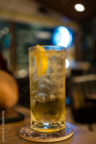 Cocktail, Tom Collins, Front view on table at nigth pub photo