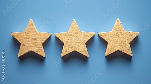 Three Wooden Stars on Blue Background: A Symbol of Three-Star Rating or Review photo