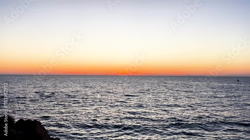 Serene peaceful ocean waves gently washing ashore during sunset golden hour