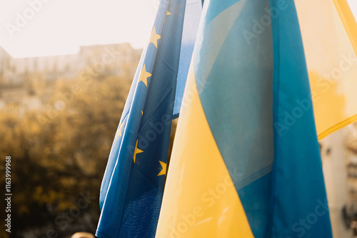Ukrainian and European Union flags at a rally against the war