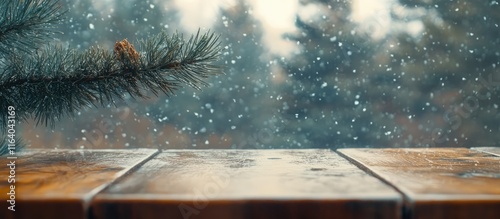 Wood table top with blurred window view of pine tree in snowy winter morning atmosphere creating a serene and cozy ambiance