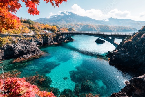 A vibrant scene of the Jogasaki Coast in Izu, featuring the suspension bridge over jagged volcanic rock formations photo