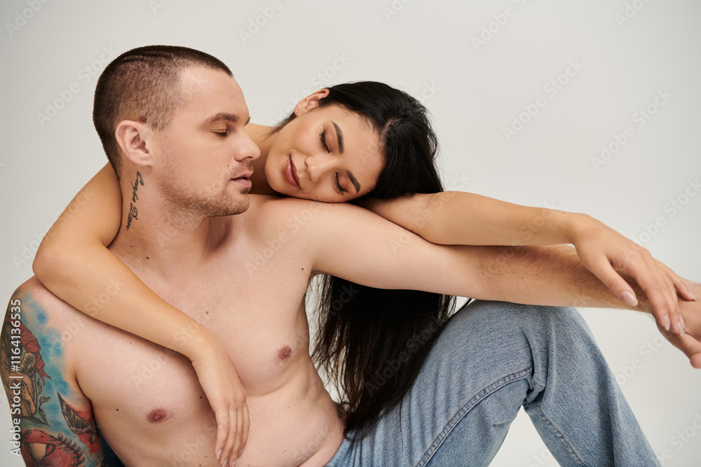 A young couple expresses deep affection in a cozy studio, capturing a moment of romance. A young couple expresses deep affection in a cozy studio, capturing a moment of romance.