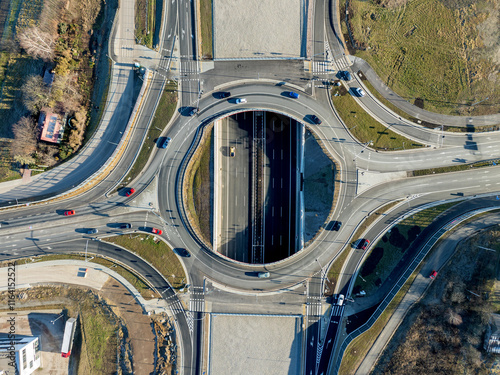 Krakow, Poland. Wegrzce interchange on new S52 highway (below) opened on December 23, 2024. Part of freeway around Cracow. Traffic circle with a hole inside and ramps. Aerial view from above at sunset photo