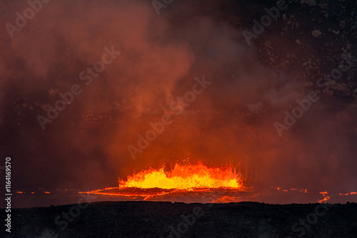 Boiling lava at night at Kilauea Volcano Hawaii just before a larger eruption that will devastate the local community. photo