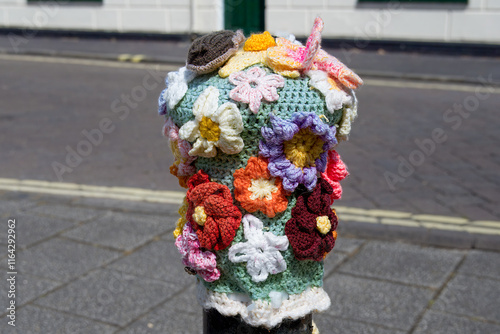 knitted bollard topper in Titchfield Hampshire England with spring flowers and butterflies photo