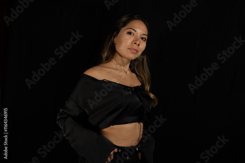 posing latina woman posing on camera with black background photo