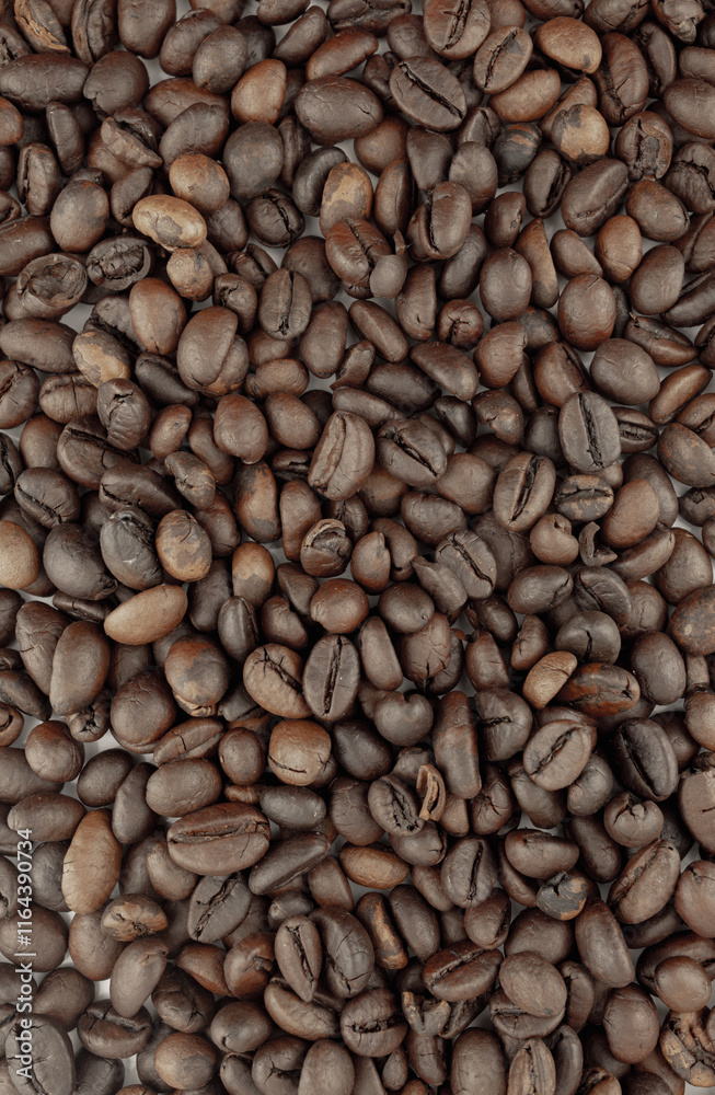 Fototapeta premium Roasted coffee beans, rich brown color, close-up view. Perfect for coffee shop menus, packaging, or websites.