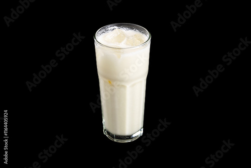 tiger nut milk with black background and ice inside of it 