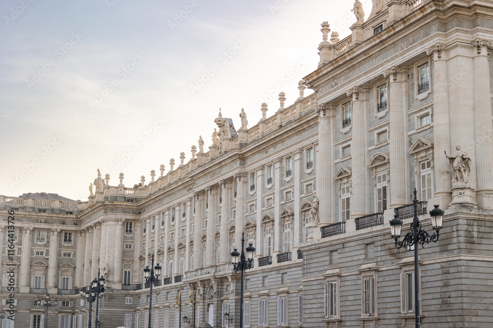 Obraz premium Views of the Royal Palace in Madrid, Spain at sunset. The Royal Palace of Madrid is the official residence of the King of Spain; however, the royal family does not live there, but in the Zarzuela Pal
