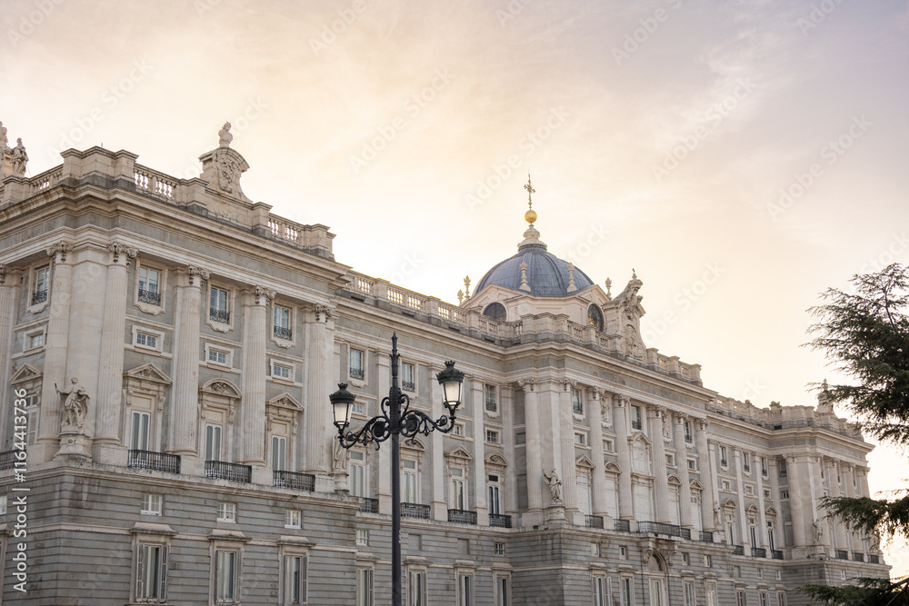 Obraz premium Views of the Royal Palace in Madrid, Spain at sunset. The Royal Palace of Madrid is the official residence of the King of Spain; however, the royal family does not live there, but in the Zarzuela Pal