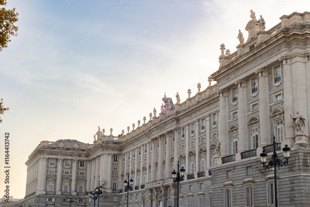 Fototapeta premium Views of the Royal Palace in Madrid, Spain at sunset. The Royal Palace of Madrid is the official residence of the King of Spain; however, the royal family does not live there, but in the Zarzuela Pal