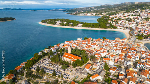 Primošten(Primosten), a picturesque coastal town on the Adriatic Sea in Croatia, captivates with its charming old town, crystal-clear waters, and stunning beaches captured from the drone
 photo