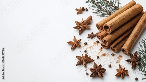 Cinnamon Sticks and Spices on White Background with Evergreen Sprigs and Star Anise for Seasonal Culinary and Aromatic Themes photo