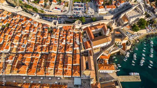 Dubrovnik, the UNESCO World Heritage city on the Adriatic coast of Croatia, captured from a drone, showcases its iconic medieval walls, historic old town, and stunning terracotta rooftops photo