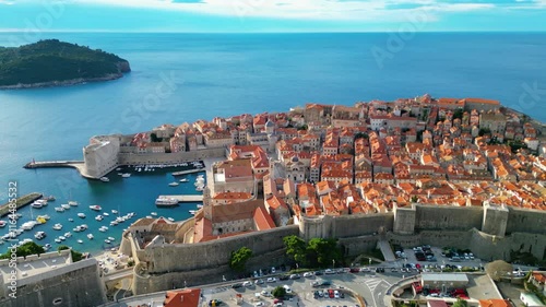 Dubrovnik, the UNESCO World Heritage city on the Adriatic coast of Croatia, captured from a drone, showcases its iconic medieval walls, historic old town, and stunning terracotta rooftops photo