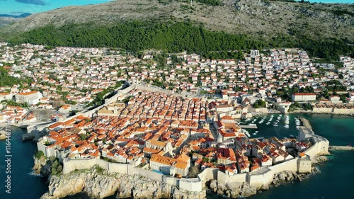 Dubrovnik, the UNESCO World Heritage city on the Adriatic coast of Croatia, captured from a drone, showcases its iconic medieval walls, historic old town, and stunning terracotta rooftops photo