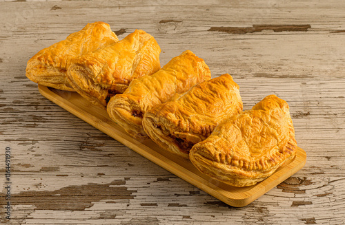 roissants in a Wooden Tray on Rustic Wood photo