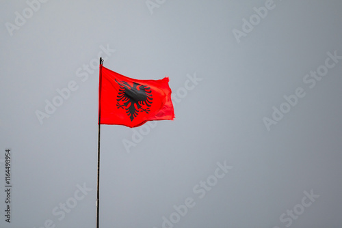 Albanian flag against dark sky in Kruja, Albania photo