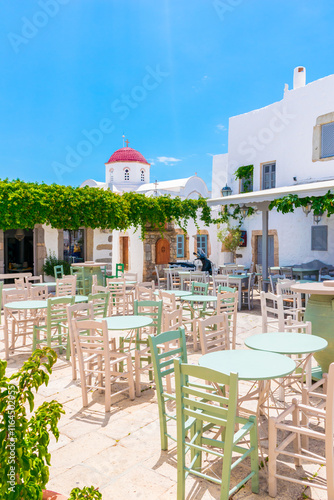 Santa Lesbia Square on Patmos island, Greece with tavernas and colourful tables and chairs during day photo