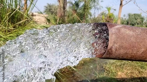 Slow Motion Footage of Tube Well Water. Water is coming out from a Tube Well. Irrigation water flow from pipe for agriculture fields. slow motion water flash. Beautiful 4k footage.